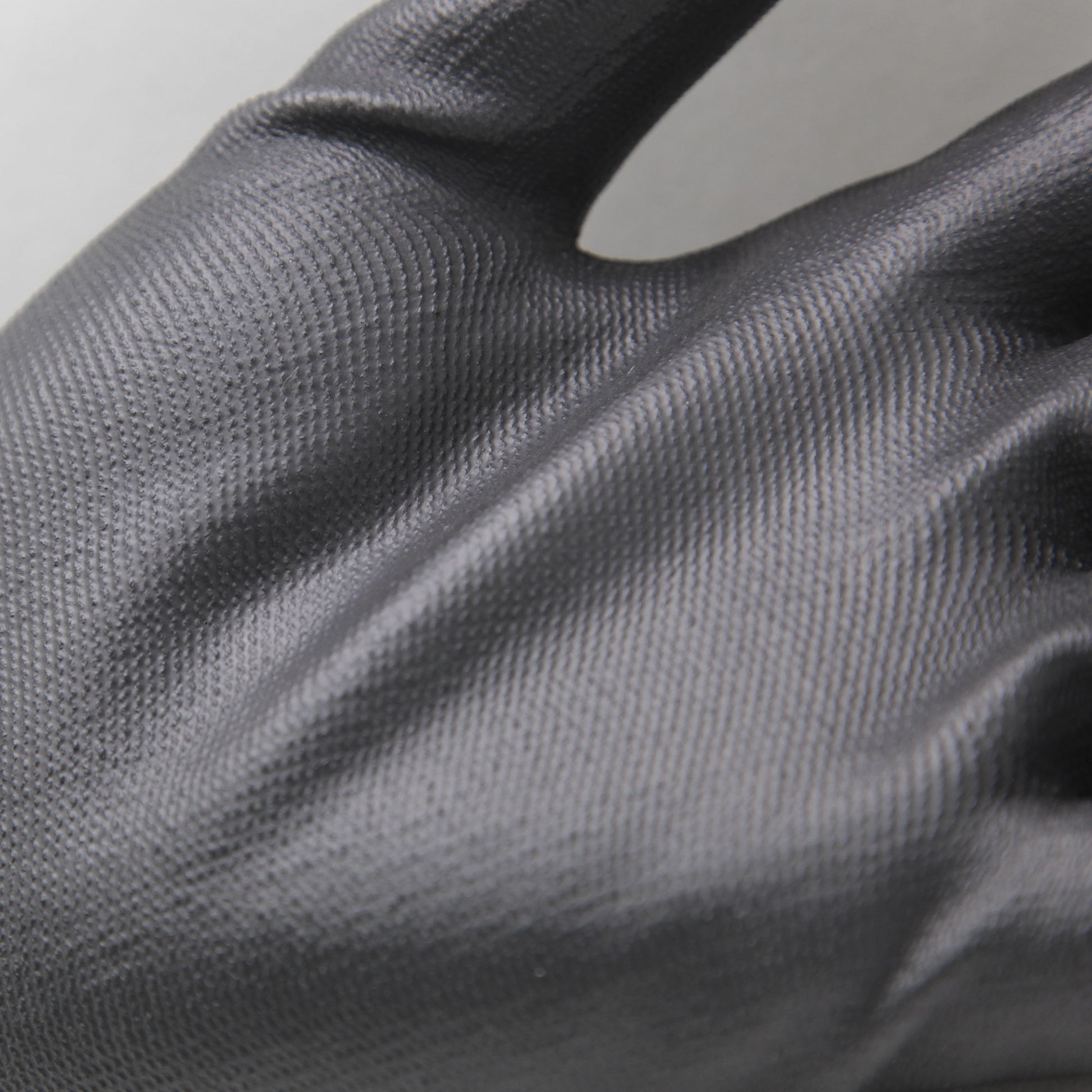 Detalj av arbetshandske Soft Touch Precision i nylon med tunn och slitstark struktur