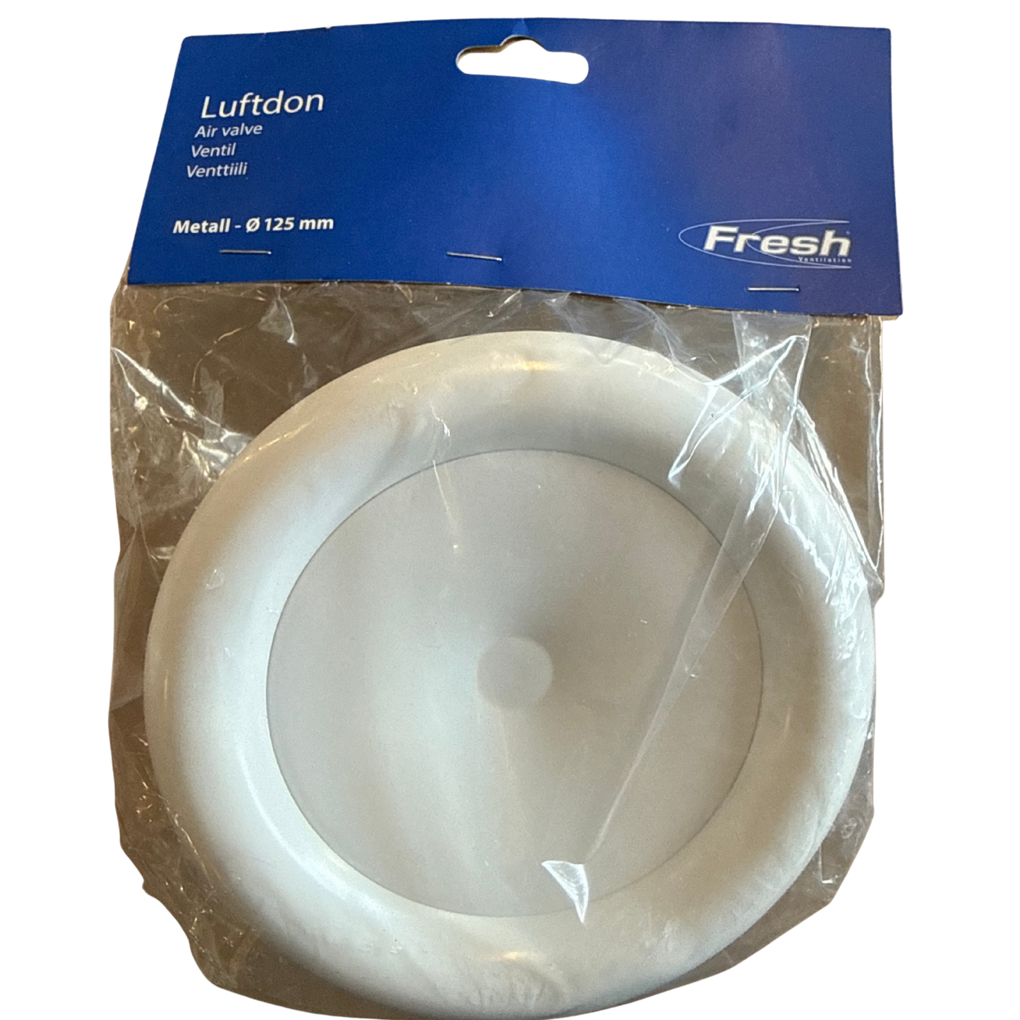 Rund vit tallriksformad luftventil i metall, synlig genom förpackningens plast