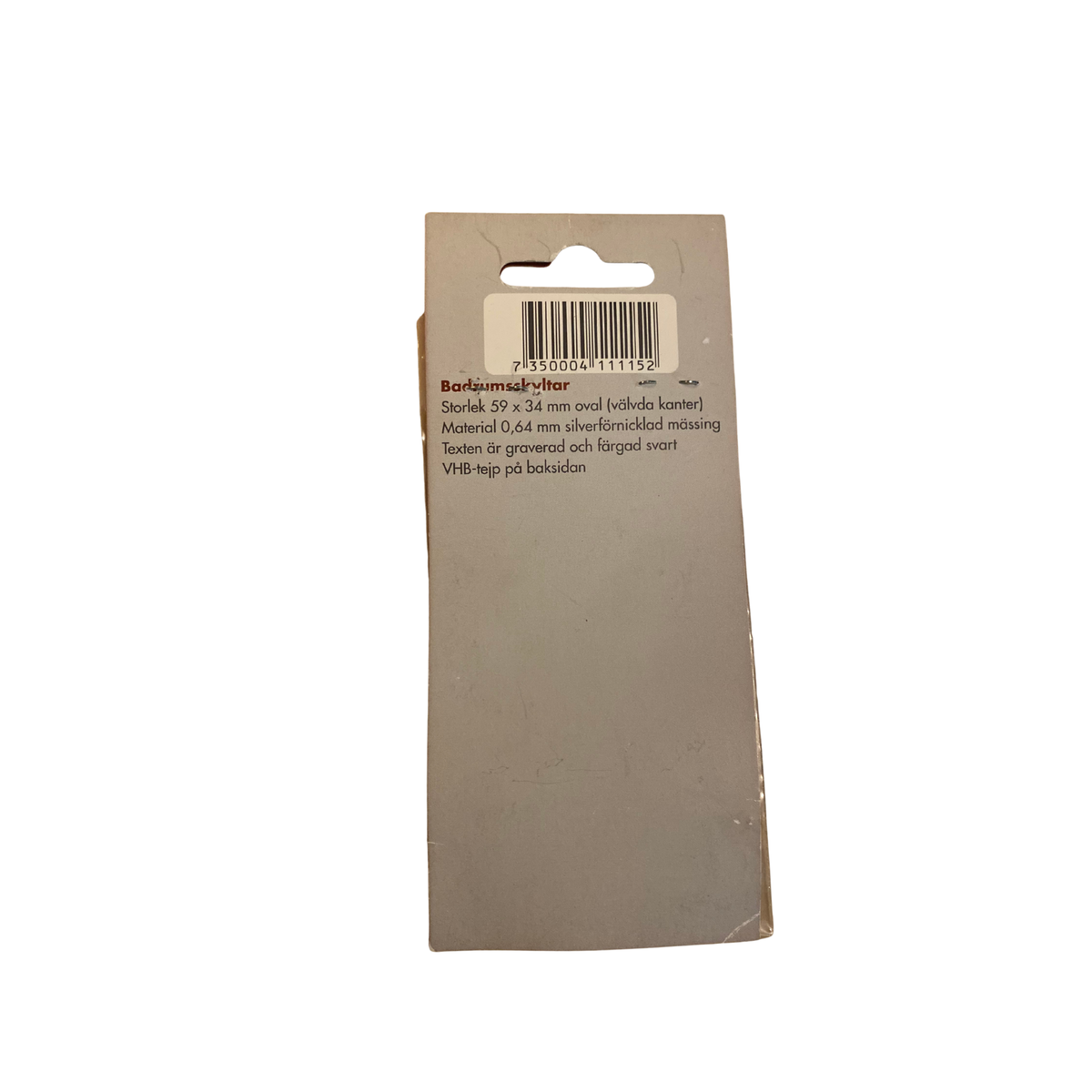 Baksida av förpackning för oval badrumsskylt Bad med streckkod, mått 59 x 34 mm och VHB-tejp